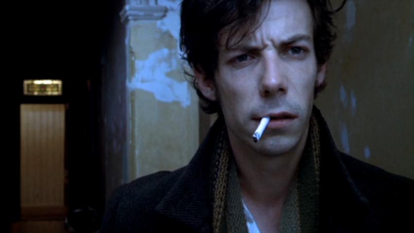 Noah Taylor smoking a cigarette (or weed)
